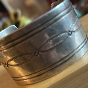 Vintage Navajo sterling silver cuff bracelet featuring hand-stamped designs.